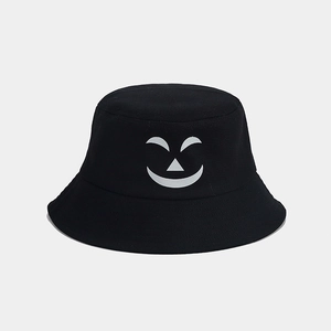 Close-up of Halloween bucket hat with a glowing cartoon pumpkin ghost face design