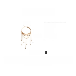 Macro detail of golden tassel armlet with heart charms and multi-layer chain design