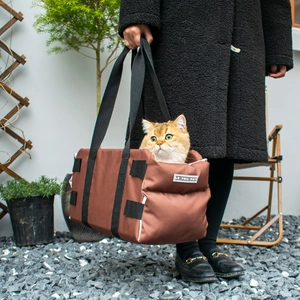 Brown canvas dog car seat carrier and shoulder bag for small pets shown in use