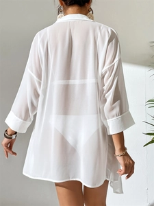Detail of white sheer chiffon beach cover-up shirt showing fabric texture and cuff button