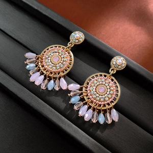 Detail of vintage bohemian dangle earrings with crystal mandalas and pastel beads