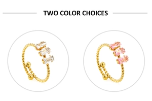 Detail showing two gold twist band rings with clear and pink rectangular zircons