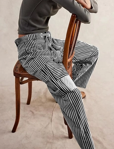 Detail view of black and white striped casual pants with drawstring waist and pockets