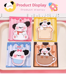 Close-up of four cute cartoon dog sticky notes sets in a pastel desktop stationery tray