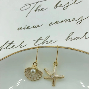 Asymmetric starfish and shell drop earrings with white pearls and gold metal hooks