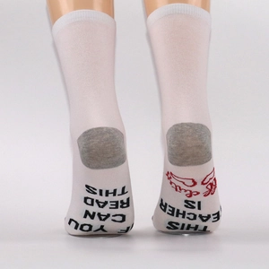 Detail showing humorous text print on white cotton crew socks with grey heels