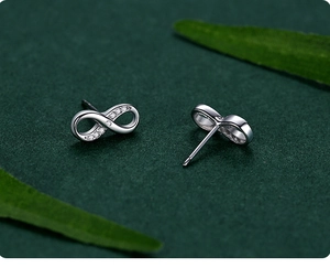 Macro detail of S925 sterling silver infinity earrings with sparkling zircon stones