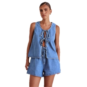 Women's two-piece denim set featuring a sleeveless lace-up vest and high-waisted shorts