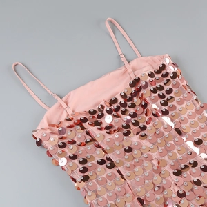 Close-up of pink sequined evening dress with mesh fabric and adjustable shoulder straps