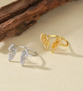 Macro shot of silver and gold butterfly open rings with pavé cubic zirconia inlay