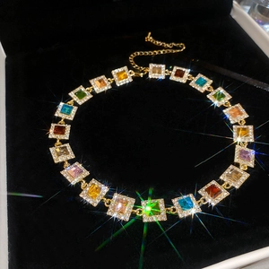 Vintage gold necklace with colorful gemstones in black velvet box with sparkle effect