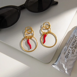 Gold multi-loop earrings with red chili pendants in bohemian style on modern setup