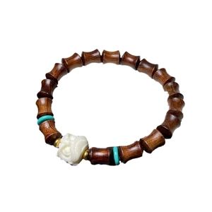 Chinese style rosewood bracelet featuring dark brown beads and a white carved flower