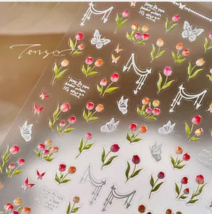 Detailed macro view of 3D tulip and butterfly self-adhesive nail art stickers