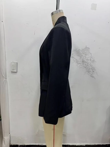 Vue latérale d'un blazer noir cintré avec épaulettes et poches à rabat pour femmes