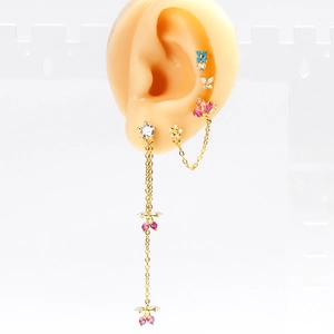 Elegant 4-piece gold earring set with zircon butterflies and pink flower charms on model