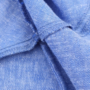 Detailed macro view of blue fabric texture and professional stitching on the tiered dress
