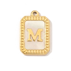 Close-up of golden letter M pendant featuring a polished shell inlay on white background