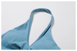 Close-up of foggy blue yoga top featuring high-elastic fabric and halter neck stitching