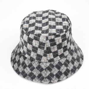 Close-up of black and grey checkerboard pattern on winter wool bucket hat texture