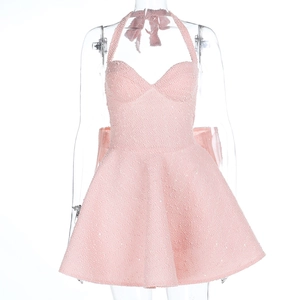 Detail of pink sequined tweed fabric on halter mini dress with shimmering texture