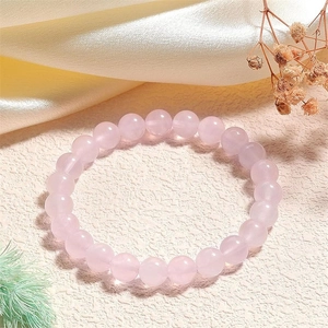 Close-up of 8mm rose quartz beaded bracelet with natural pink gemstones on elegant display