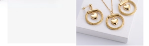 Detailed view of gold heart jewelry set including matching earrings and pendant necklace
