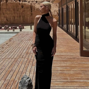 Detail of elegant black backless halter evening dress with a slim fit and long hemline