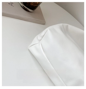 Detailed close-up of neat stitching on a high-quality white leather tote bag base