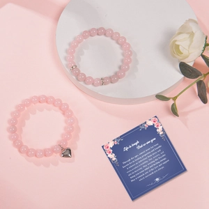 Detail of pink zebra stone beaded bracelets with heart charm and a message card