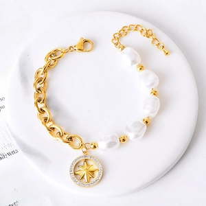 Golden titanium steel bracelet with baroque pearls and a sparkling star pendant
