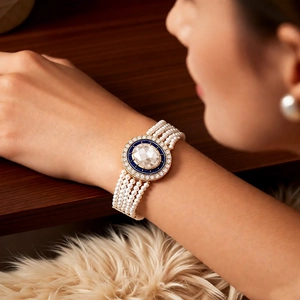 Detailed macro of vintage pearl bracelet with blue enamel and crystal centerpiece