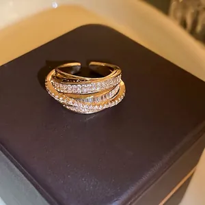 Elegant multi-layer gold open ring featuring sparkling zircon pavé and layered design