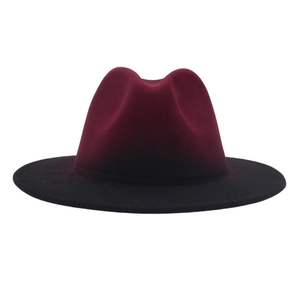 Detail of burgundy and black two-tone gradient felt fedora hat with a wide brim