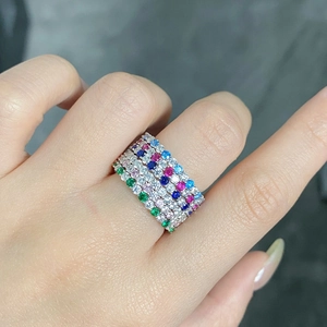 Detailed view of stacked multi-row rings featuring colorful round-cut zircon gemstones