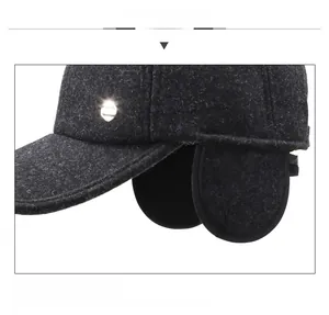 Detail view of winter baseball cap featuring wool blend fabric and integrated ear flaps