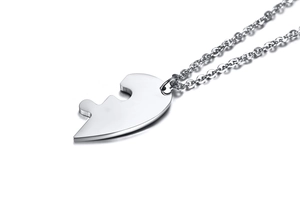 Detailed view of silver puzzle heart pendant on stainless steel chain necklace