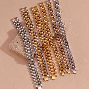 Detail view of 18K gold and silver stainless steel watchband style bracelets on stones