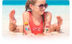 Waterproof glitter temporary tattoos with summer dinosaur and mermaid motifs on child's arm