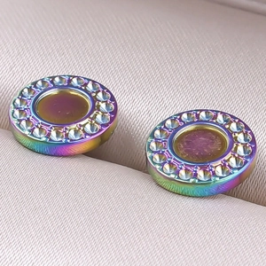 Macro shot of circular rainbow stainless steel stud earrings with crystal halo