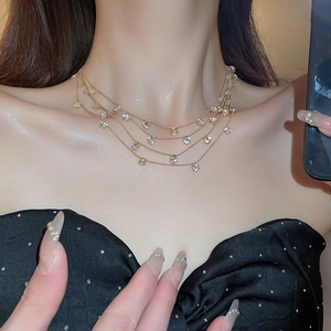 Close-up of elegant multi-layer gold fringe necklace with sparkling round zircons