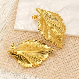 Golden leaf-shaped stainless steel stud earrings with natural vein texture detail