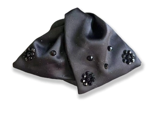 Detail of black satin double bow hair claw clip with subtle beads and shimmering texture