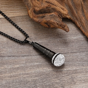 Macro shot of hip-hop black microphone pendant with crystal studs and box chain
