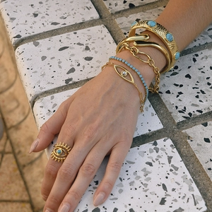 Detailed view of 18K gold-plated stainless steel Evil Eye bracelets and turquoise jewelry
