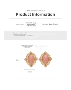 Detailed view of vintage oval earrings featuring pink opal and white enamel with rhinestones