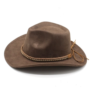 Close-up of brown suede cowboy hat featuring woven band and gold metal bead accents