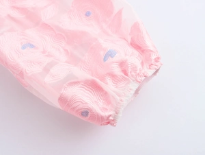 Close-up of pink jacquard dress elastic cuff featuring delicate floral embroidery detail