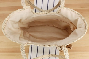 Interior view of large capacity straw bag showing fabric lining and inner pockets