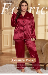 Detail view of burgundy satin plus-size pajamas featuring button-up shirt and silky texture